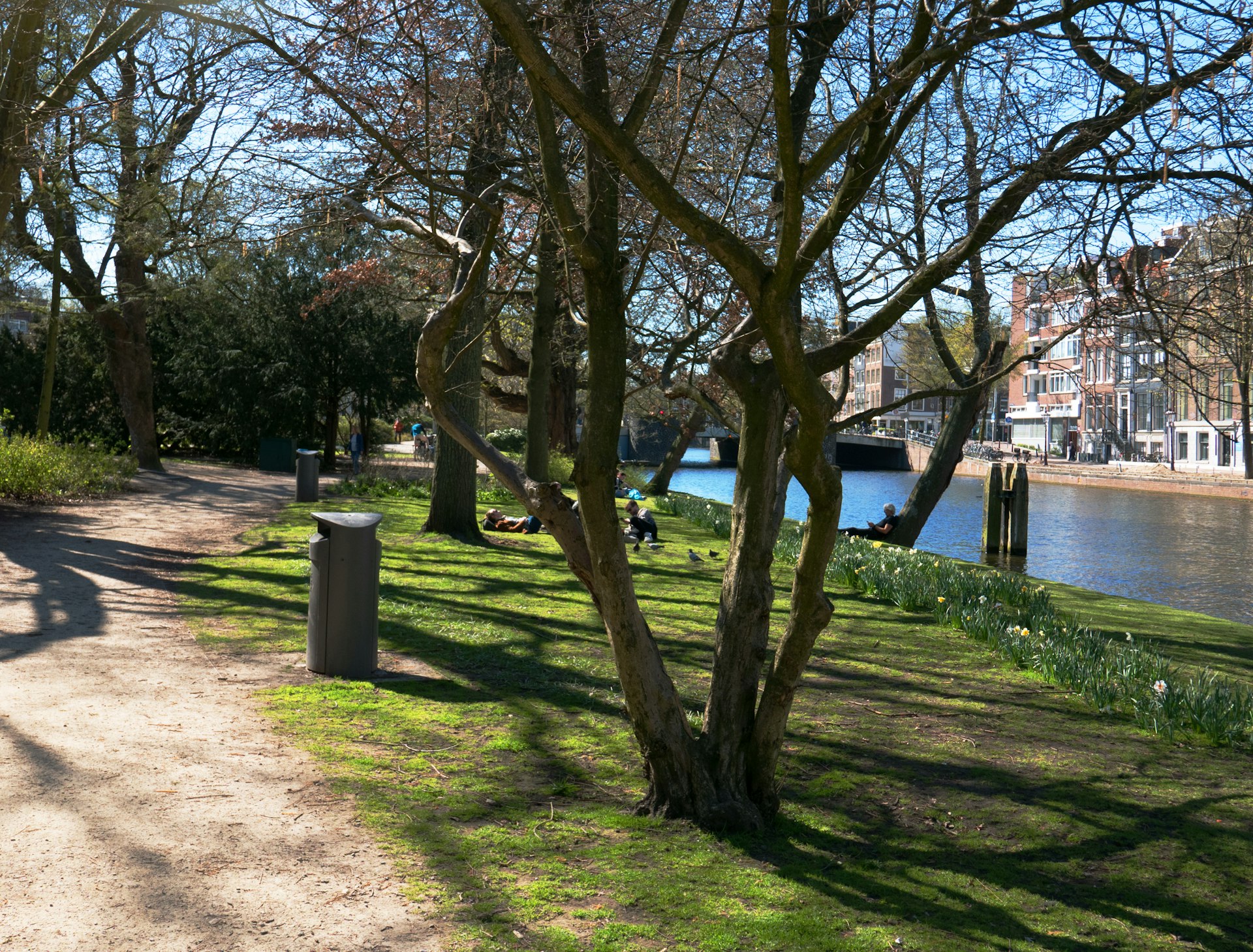 a man walking down a path next to a river
